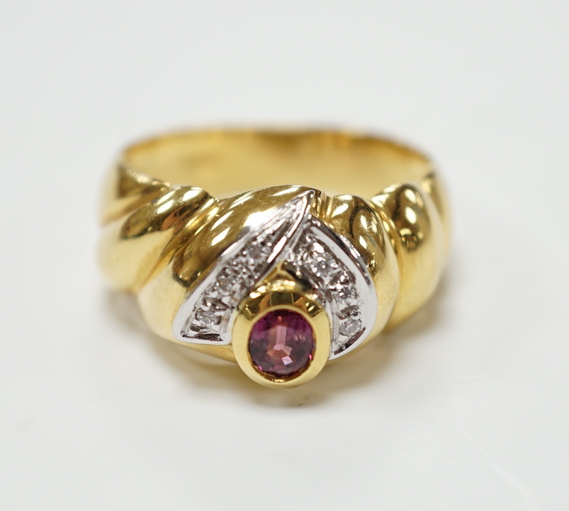 A modern 18ct gold, single stone deep pink sapphire and six stone diamond chip cluster set dress ring, size P, gross weight 8.3 grams.